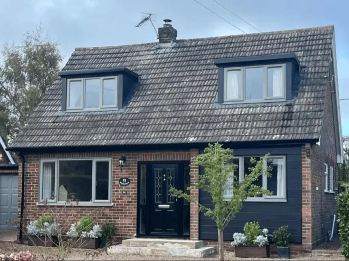 Upgraded residential front facade with energy-efficient concrete grey uPVC windows eliminating internal cold spots in Little Melton. By Norfolk Exterior Solutions